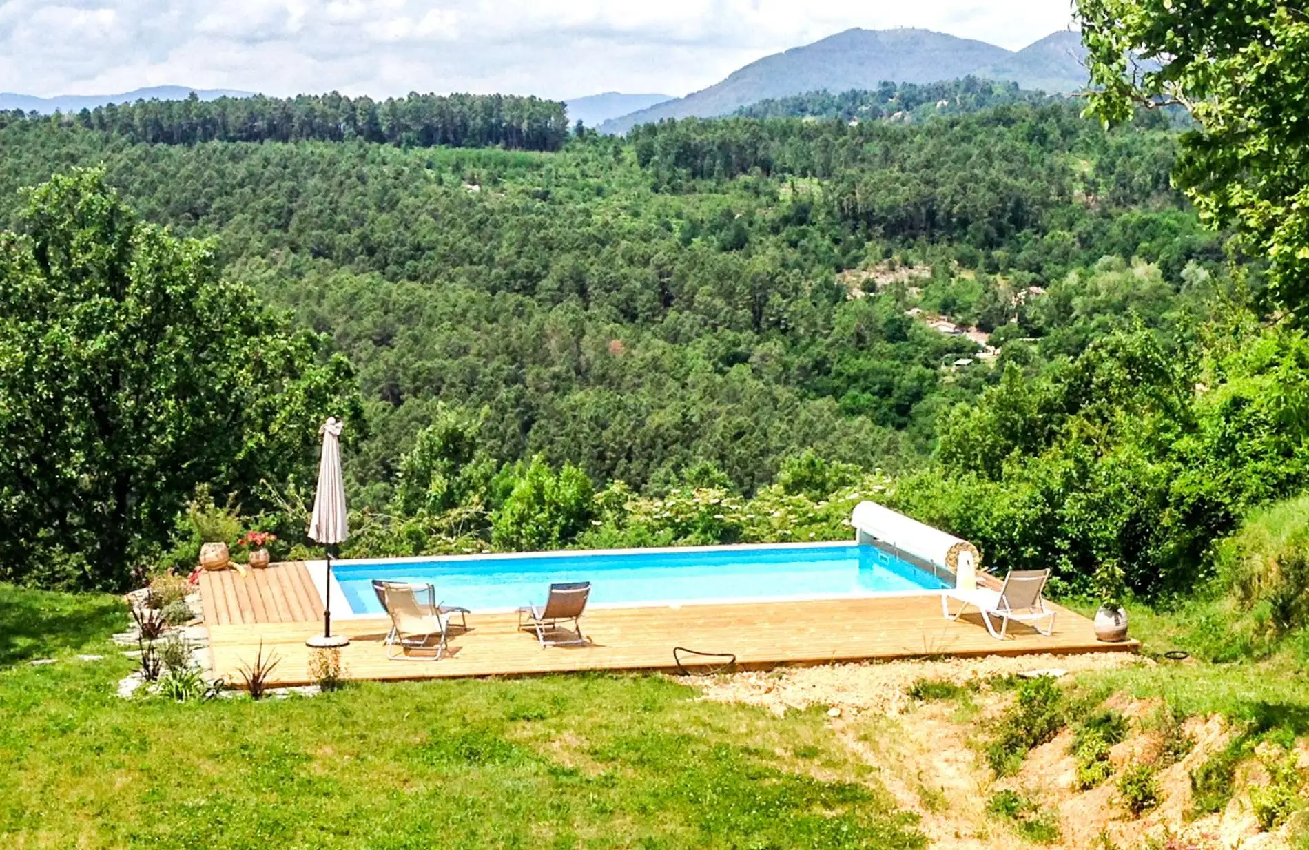 Piscine sur terrasse en bois au-dessus de la vallée boisée, sur les hauteurs de Largentière