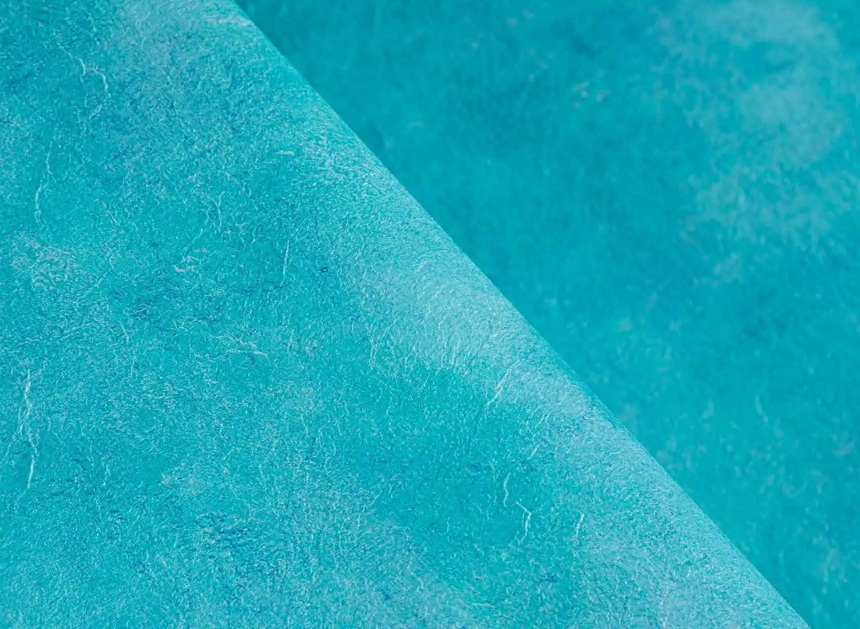 Étanchéité de piscine : rouleau de membrane armée turquoise, texture en gros plan